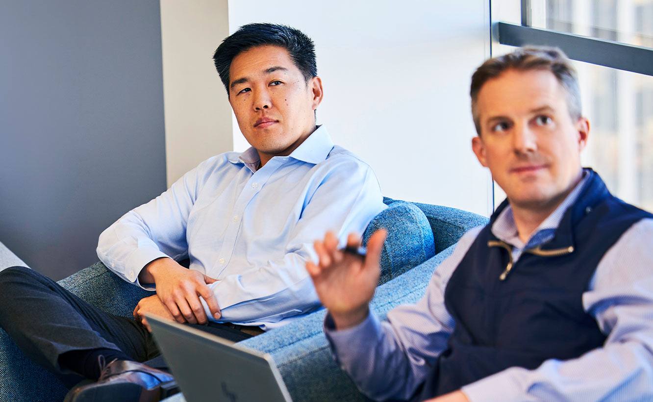 Two male professionals sitting and listening